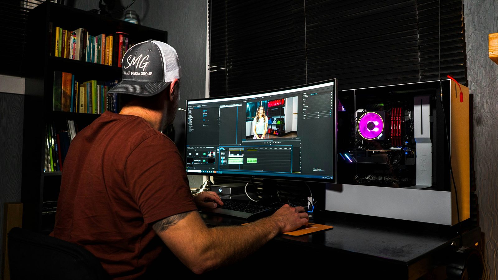 An editor working at an ultrawide monitor in the dark