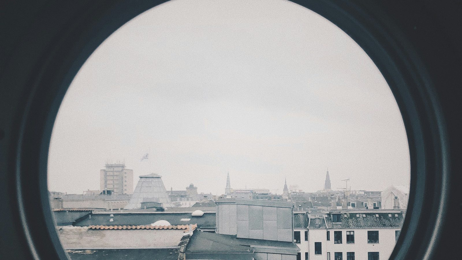 City rooftops viewed through a window