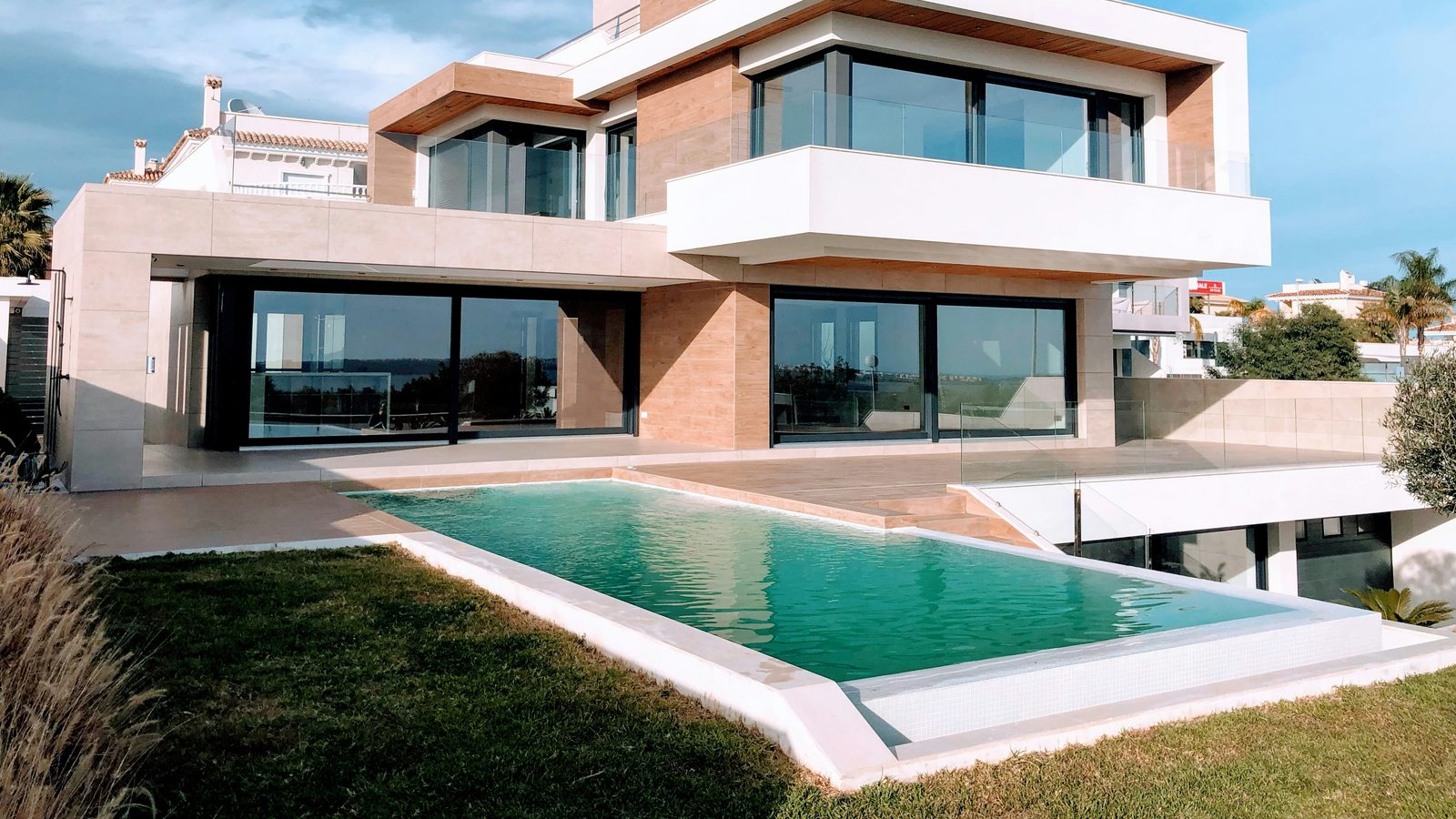 A modern luxury house with a pool at dusk