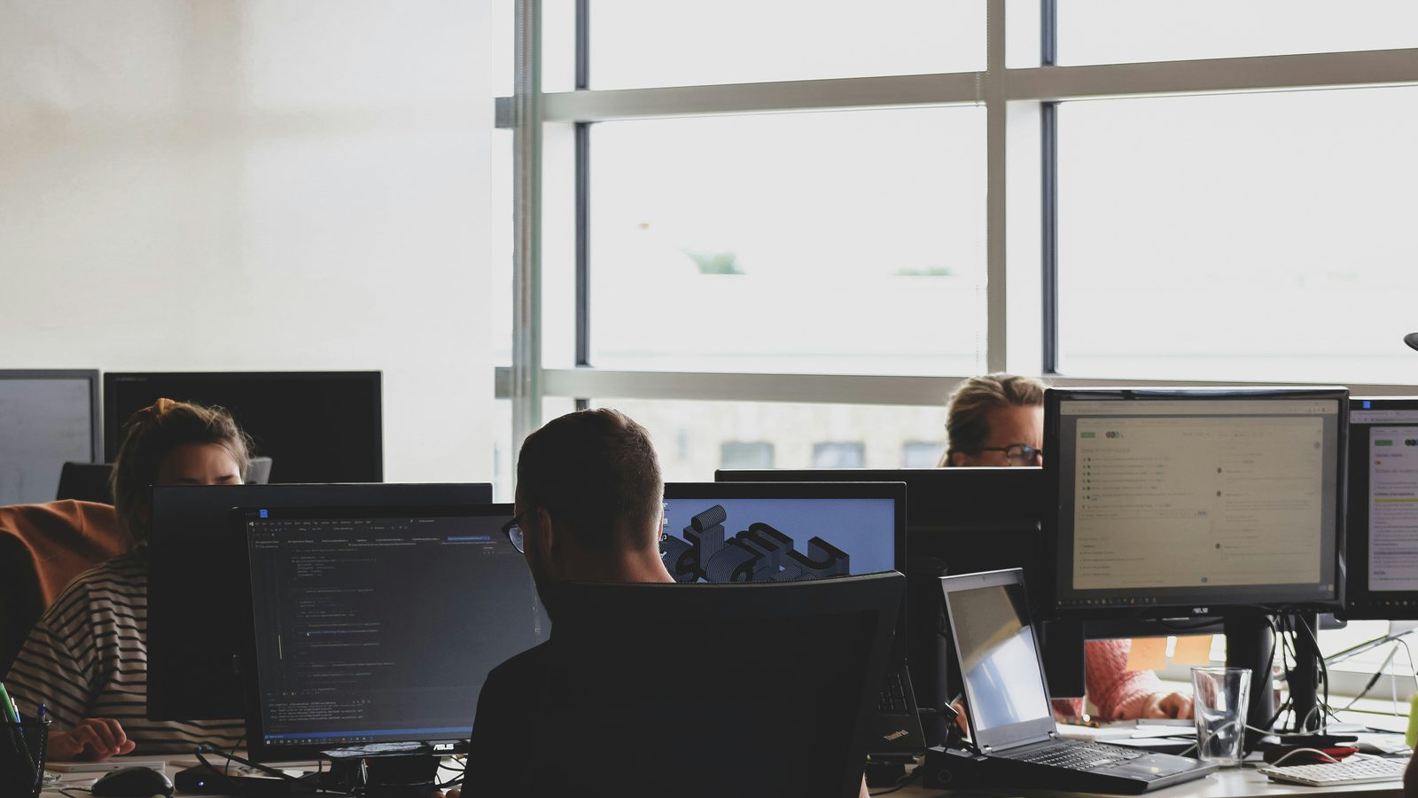 Developers working at multi-monitor workstations