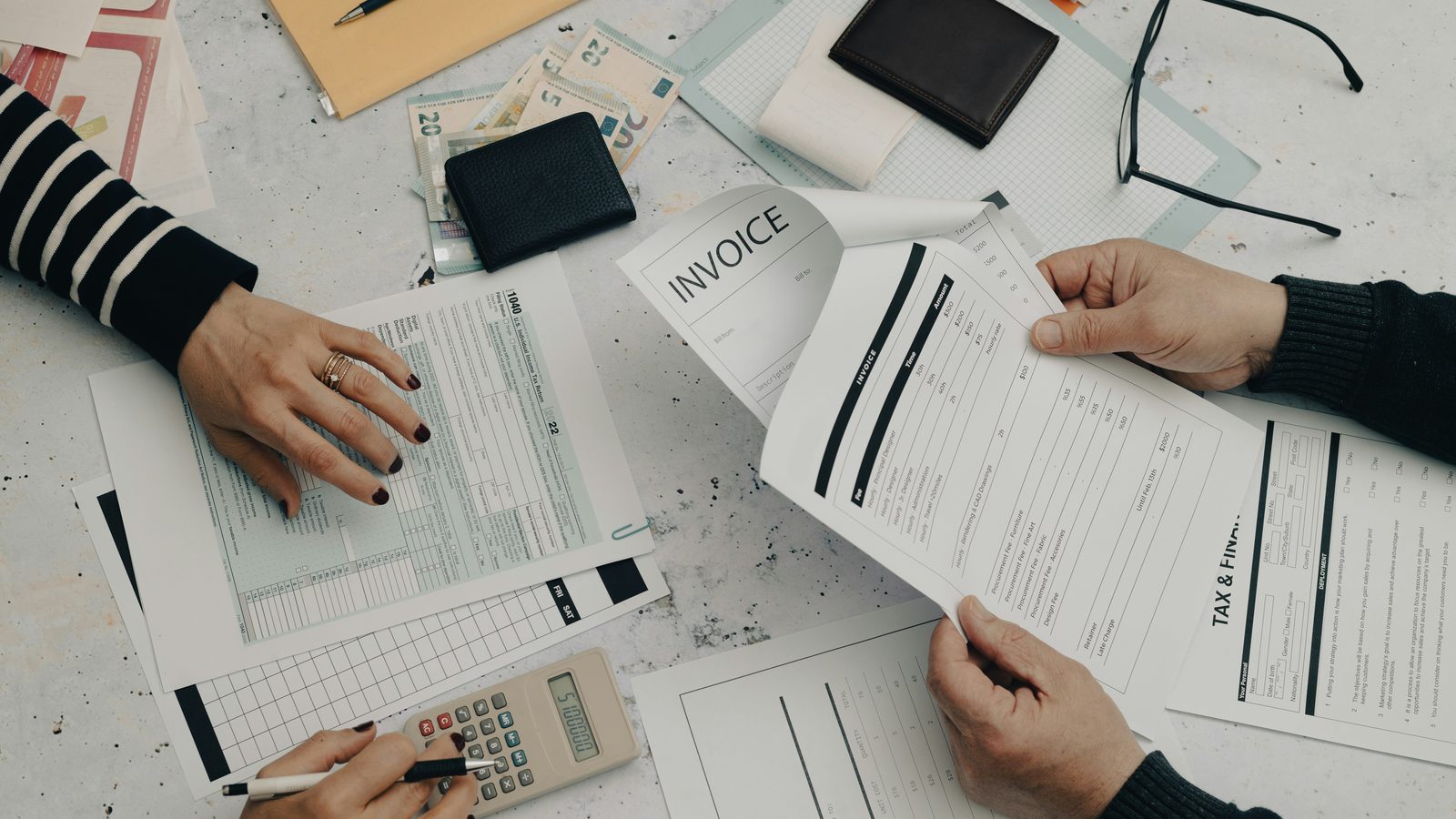 Invoices and a calculator on a desk