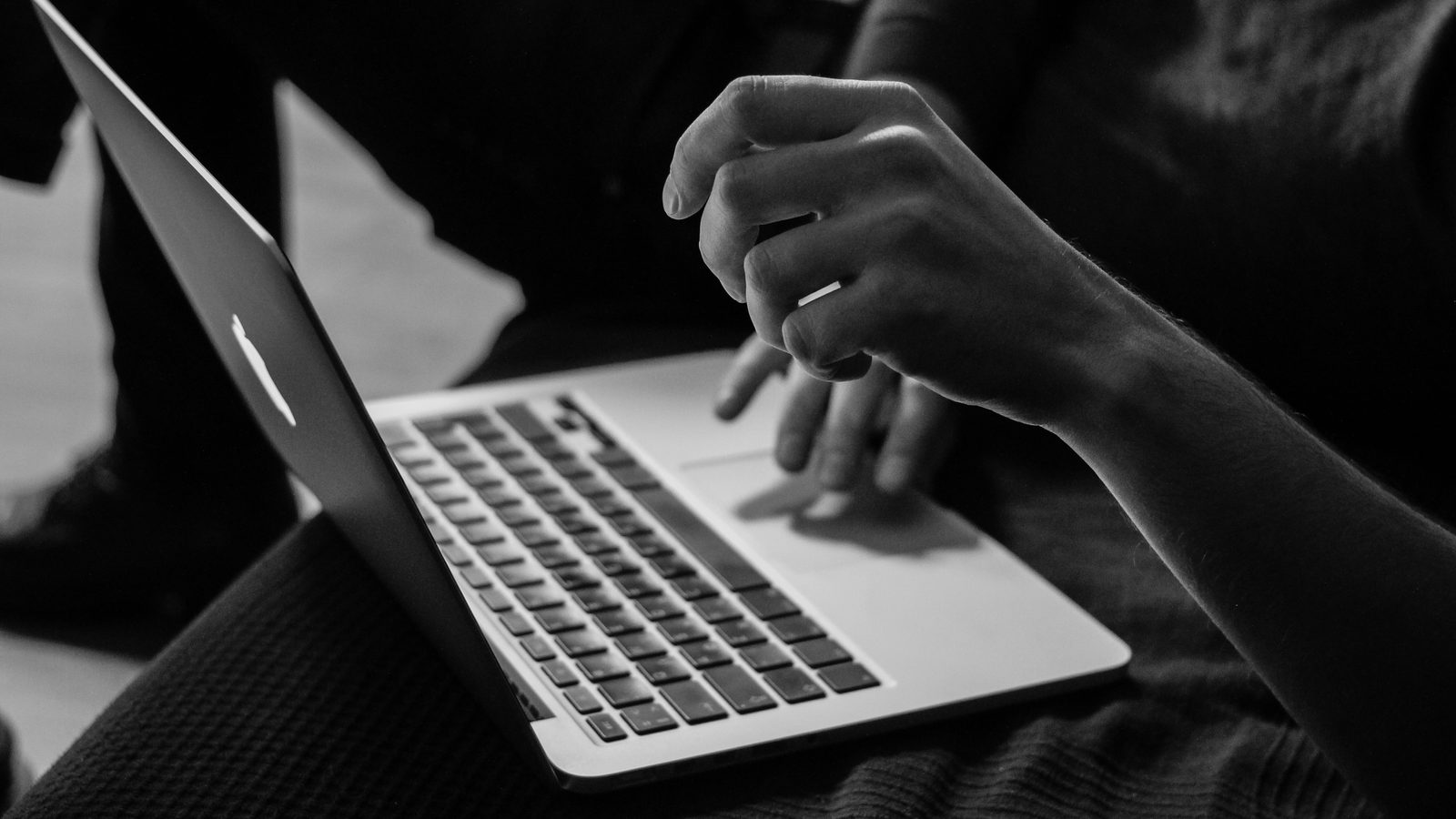 Person working on a laptop in low light